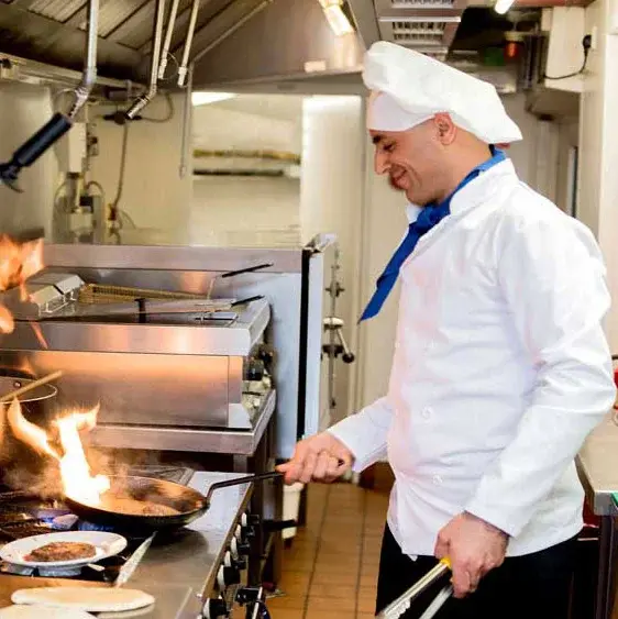 Mulligan Park Chef Created Meals, chef frying a dish.