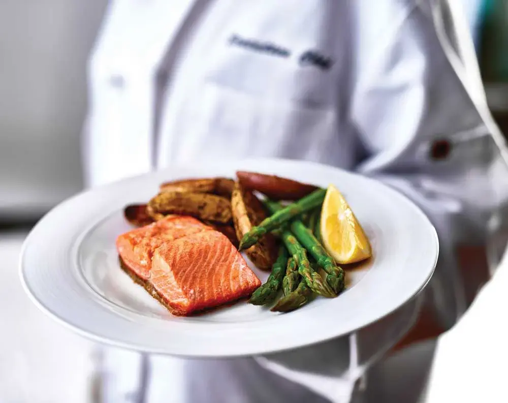Mulligan Park Chef Created Meals, chef delivering a finished dish.