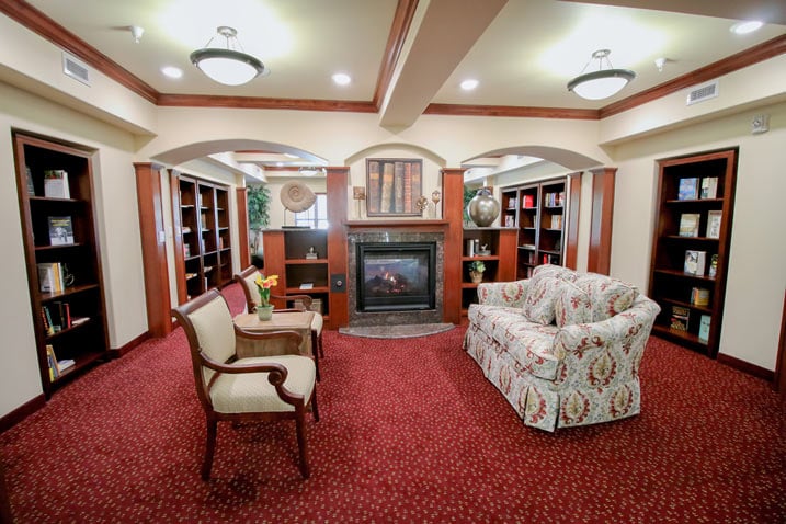 The library at Mulligan Park with shelves of books and comfortable seating